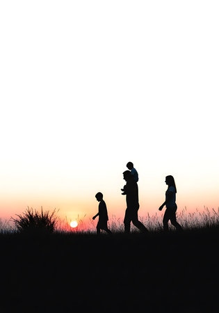 Silhouette of family walking in the field with sunset background.の素材