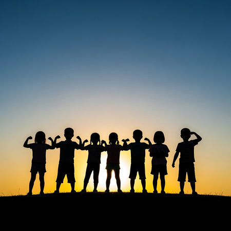 Silhouette of group of children holding hands together on sunset backgroundの素材