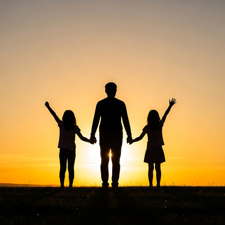 Silhouette of father and children holding hands on the sunset backgroundの素材