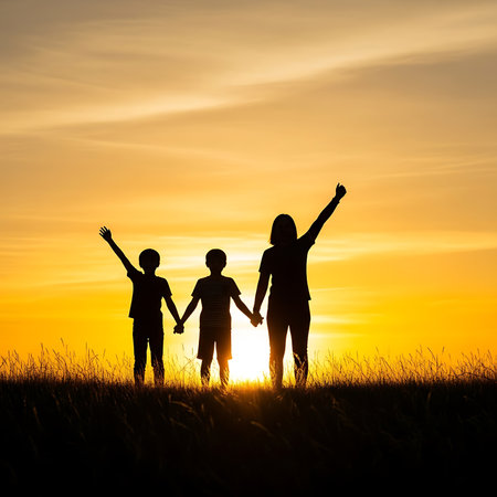 Silhouette of happy family holding hands on sunset sky background.の素材