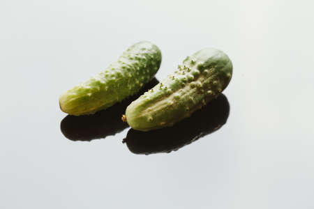 Fresh cucumbers on a dark background close up.の写真素材