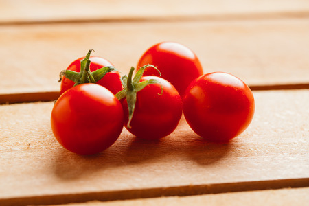 Fresh cherry tomatoes on a wooden background.の写真素材