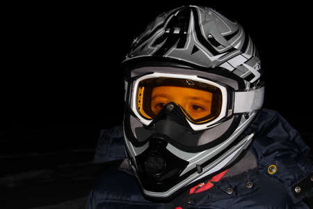 Child Wearing an ATV Helmet at Nightの写真素材