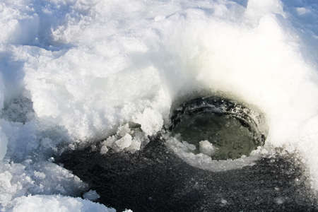 Clearing a Freshly Dug Hole for Fishingの写真素材