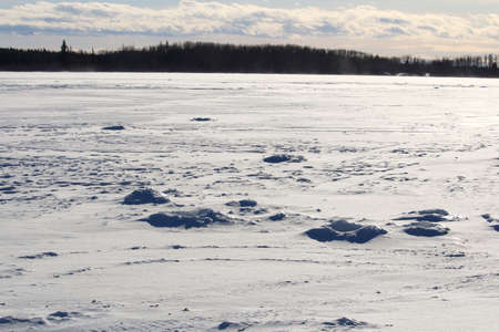 Old Ice Fishing Holes on a Windy Lakeの写真素材