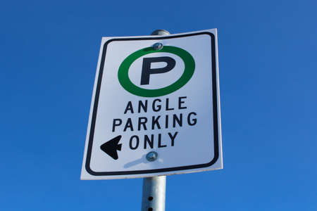 Angle Parking Only Sign Against Blue Sky.の写真素材