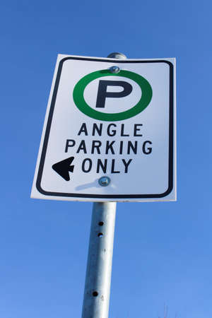 Angle Parking Only Sign Against Blue Sky.の写真素材