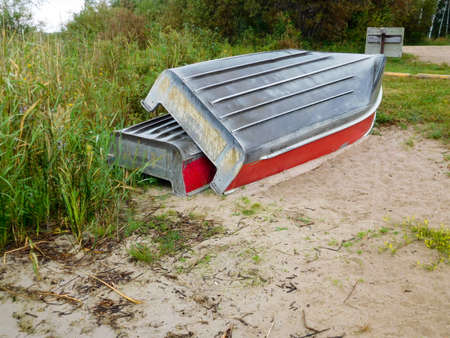 Two aluminum boats pulled up on shore.の写真素材