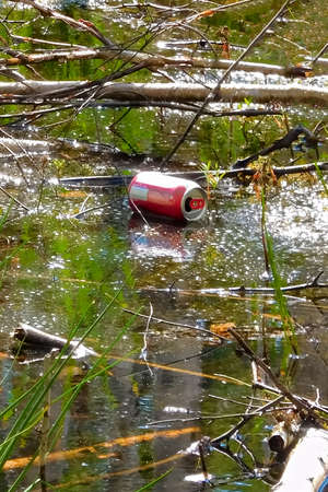 Pop can floating on water.