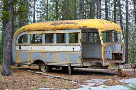 Stripped abandoned bus at a hunters camp on crown land.の写真素材