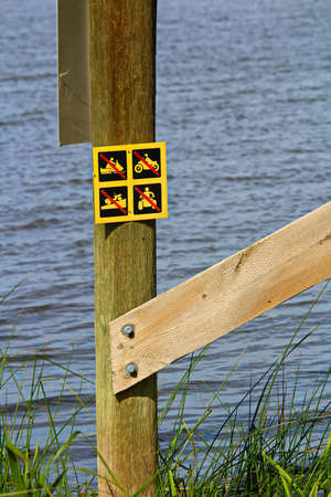 No off-road vehicle sign posted near water.