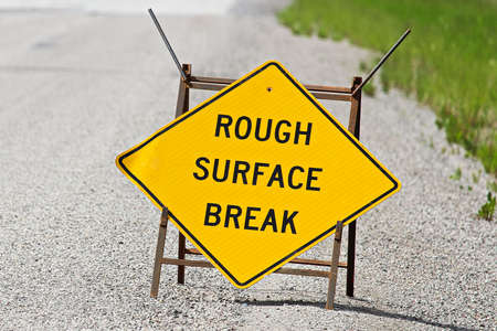 Closeup of a yellow rough surface break sign on pavement.の写真素材