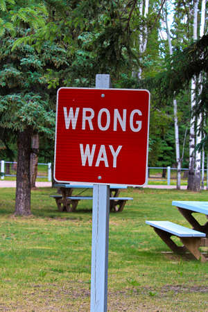 A red wrong way sign with picnic tables behind it.の写真素材