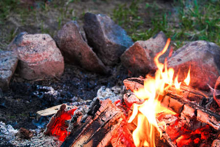 A campfire with a ring of stones around it.の写真素材