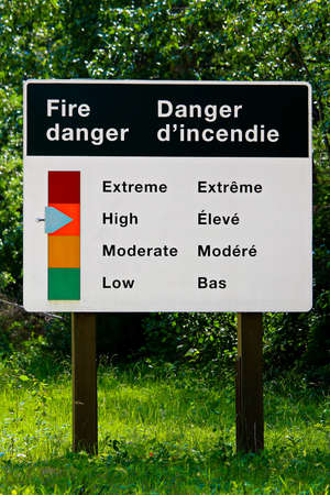A fire danger indicator sign in both english and french.の写真素材