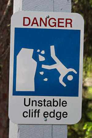 A danger unstable cliff edge sign.の写真素材