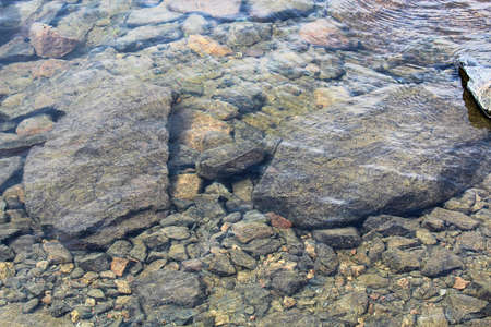 View of rocks through crystal clear water.の写真素材