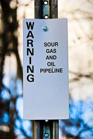 Warning sour gas and oil pipeline sign.