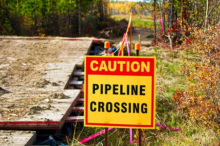 Closeup of a caution pipeline crossing sign.の写真素材