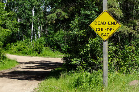 A Dead End sign beside a gravel road