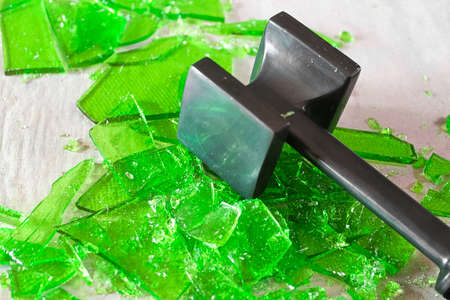 Cracking broken glass candy with a mallet.