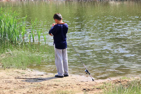 A boy getting his hook ready for fishingの写真素材