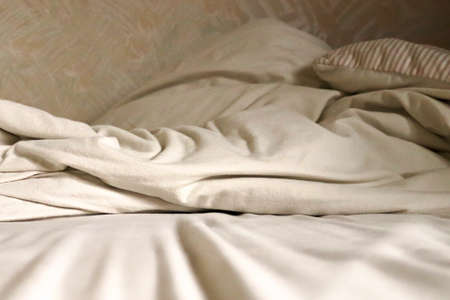 Closeup of flannel sheets and quilt on a bed