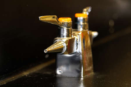A lab gas valve on a black table and backgroundの写真素材