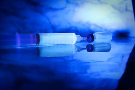Chemicals glowing under blacklight against a blue backgroundの写真素材