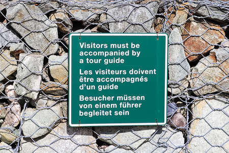 A vistors must be accompanied by a tour guide signの写真素材