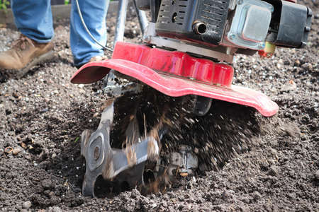 Cultivating garden soil in the spring with a rototiller