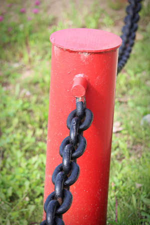 A vertical photo of a red chain link fence