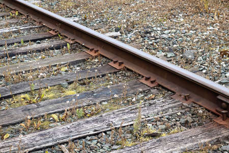 Side view of a old train track plate, spikes, rail and sleepersの写真素材