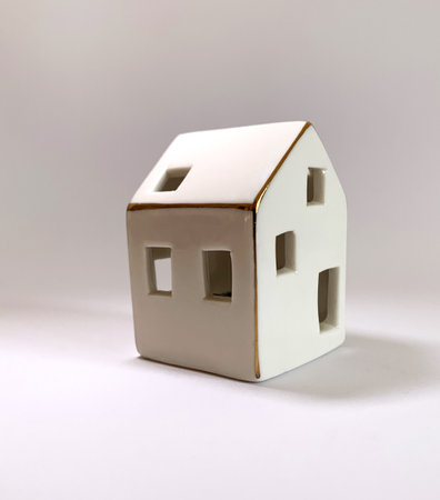 House decoration. Mini ceramic house object isolated. Porcelain miniature house. Real estate business.の写真素材