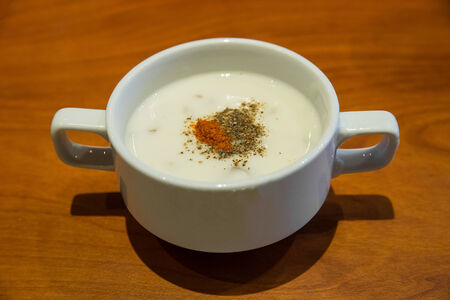 Cream soup with chanterelle mushrooms in ceramic bowlの写真素材