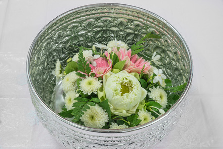 Lotus and Gerbera with Thai style decoration in silver bowlの写真素材