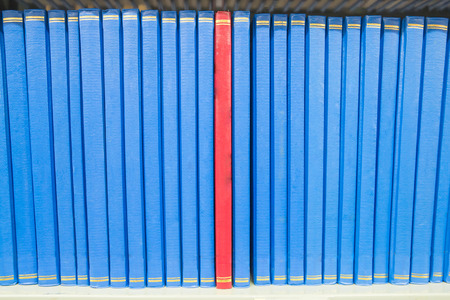 Book in a bookshelf standing out at university library の写真素材
