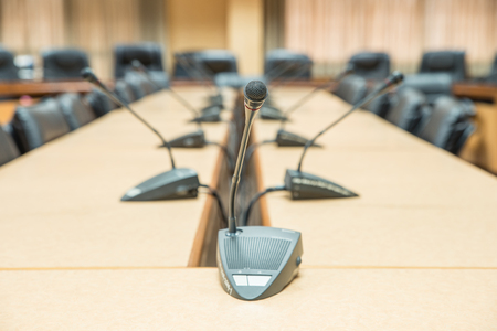 the microphones in front of empty chairsの写真素材