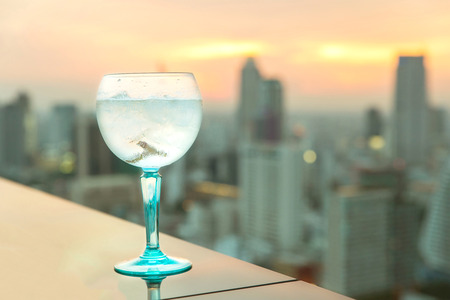 Gin tonic cocktail on table in rooftop barの写真素材