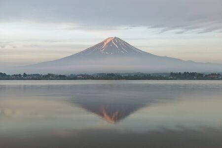 Mount Fuji reflected in Lake Kawaguchiko at dawn, Japan.の写真素材