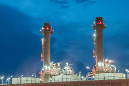 Smokestack in power plant at nightの写真素材