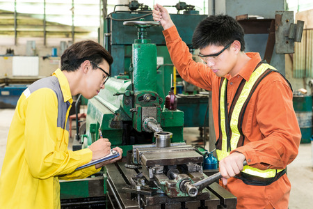 Asian Mechanical Engineer checking equipment in factoryの写真素材
