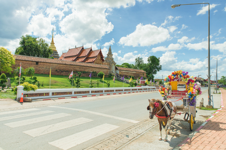 Thailand tradition Carriage with beautiful temple (Wat Prathat Lampang Luang) in Lampang, Thailandのeditorial素材