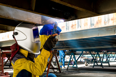 Worker repair the damage bottom side of container , Industrial , factory welding closeup