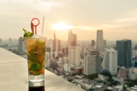 Mojito cocktail on table in rooftop bar with Bangkok city view point in Bangkok Thailand. Beautiful rooftop bar in Bangkok.の写真素材
