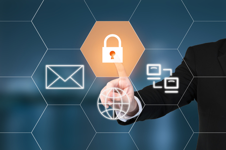 Business man pressing security button on virtual screens. Business, technology and internet conceptの写真素材