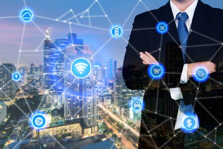 Double exposure businessman standing with his arms crossed with technology and communication icon.
