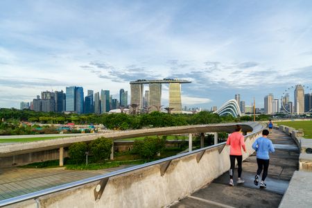 People jogging at morning in Singapore. Singapore Downtown Core in the background.のeditorial素材