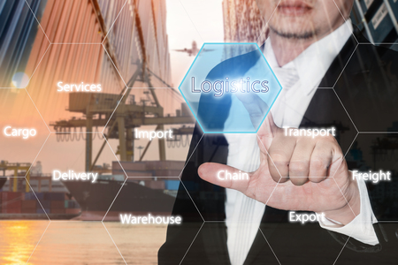 Logistics concept with businessman hand holding digital tablet shipping icons use for import, export and logistics background.の写真素材