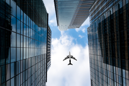 Tokyo skyscrapers buildings and a plane flying overhead at in Tokyo Shinjuku downtown and business district in morning at Tokyo, Japan.の写真素材